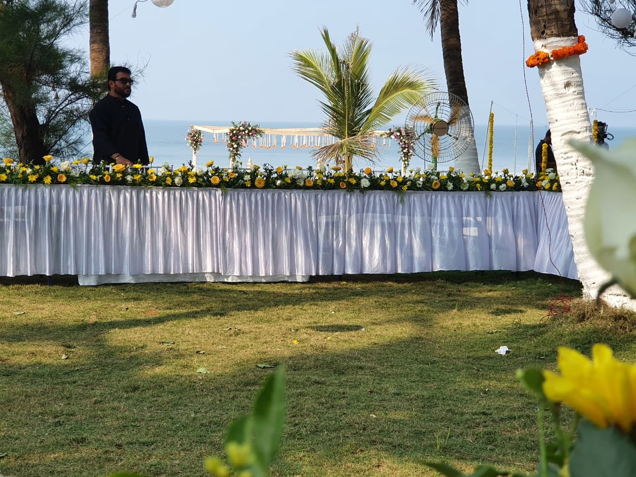 Buffet tables set up on the lawn by the beach for a celebration