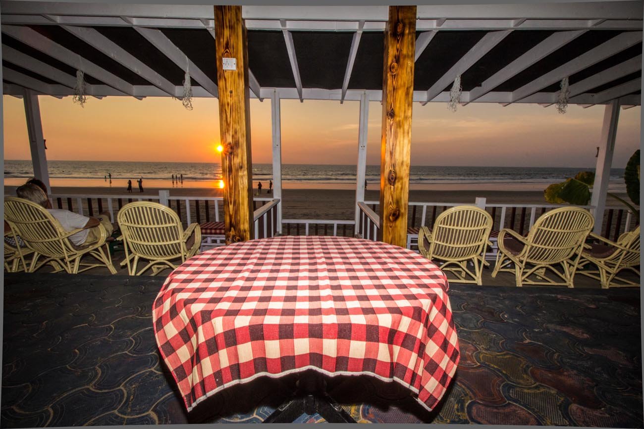 Dinner table at sunset in the beachfront restaurant