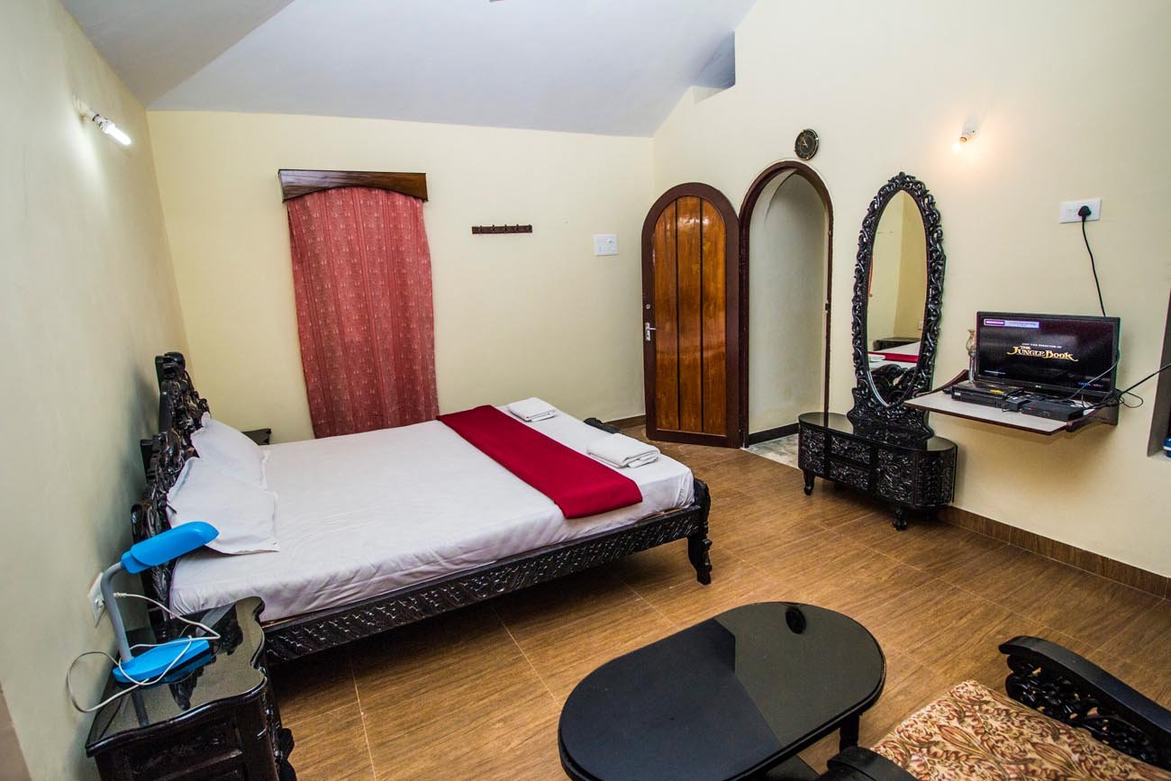 Villa bedroom with carved bed